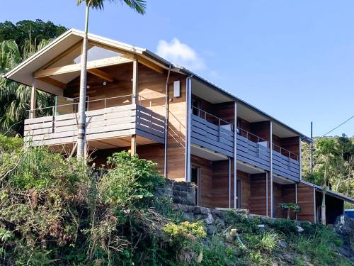 a house on the side of a hill at guesthouse Amami Long Beach2 in Koshuku