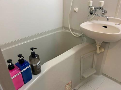 a bathroom with a sink and a bath tub with a toilet and a bidet at AO Dazaifu / Vacation STAY 61719 in Chikushino