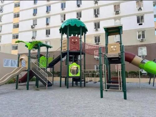a group of playground equipment in front of a building at Moonlight Melody Suite in Basbas