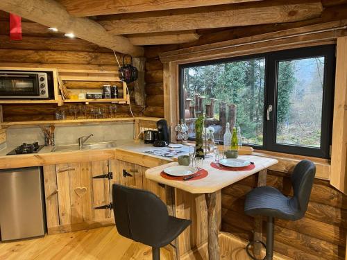 a kitchen with a table and chairs in a cabin at LA YOURTE DU RANDONNEUR in Rimbach-près-Masevaux