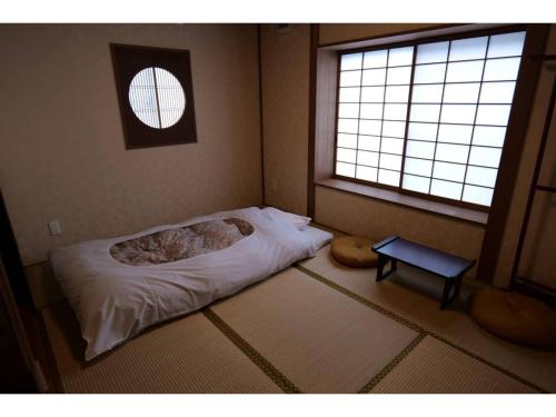 a small bedroom with a bed and a window at YAKATA - Vacation STAY 58595v in Yuzawa