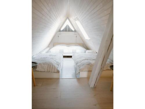 a room with two beds in a small attic at Holiday home Zum Nagel in Pommerby