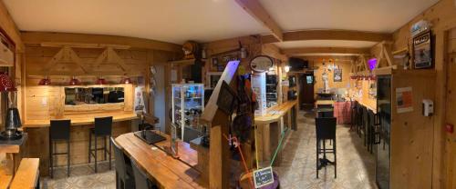 a shop with wooden walls and a counter in a room at Relais Mont Jura Adults Only in Lélex