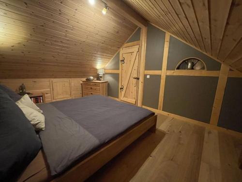 um quarto com uma cama e um tecto de madeira em Holiday home Placzek em Schierke