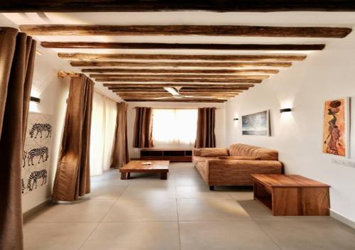 a living room with a couch and a table at The Dream Village in Kiwengwa