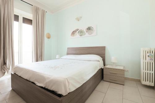 a bedroom with a large bed and a window at SAN MARTINO HOUSE in Genova