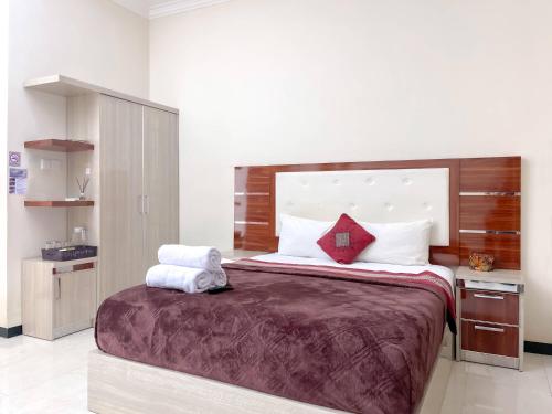 Ένα ή περισσότερα κρεβάτια σε δωμάτιο στο Soka Guesthouse Syariah