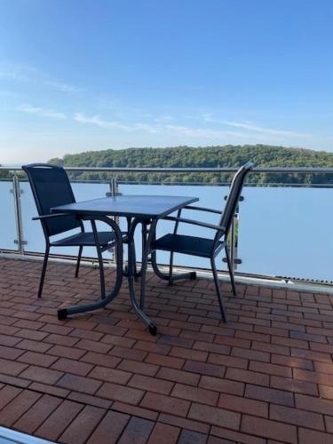 a table and two chairs sitting on a roof at Appartement 17 in Oerlinghausen