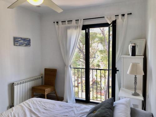 a bedroom with a bed and a large window at Vega in Begur