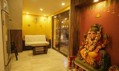 a room with a statue of a god on the wall at Hotel Shantinivas - Tarapith in Tarapith