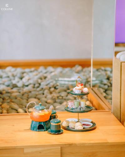 a table with two plates of food and tea sets at Colline Dalat in Da Lat