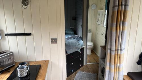 a bedroom with a bed in a small room at Cabin - Sleeps 2 hot tub & parking in Welshpool