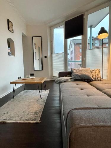 a living room with a couch and a table at Hafenbude Husum in Husum