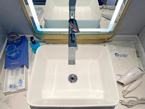 a sink in a bathroom with a faucet at Insail Hotels Guangzhou Beijing Road Pedestrian Branch in Guangzhou