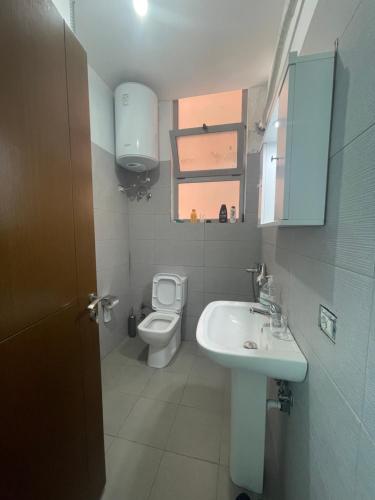 a bathroom with a sink and a toilet at Bajovah Apartments & Restaurant in Tirana