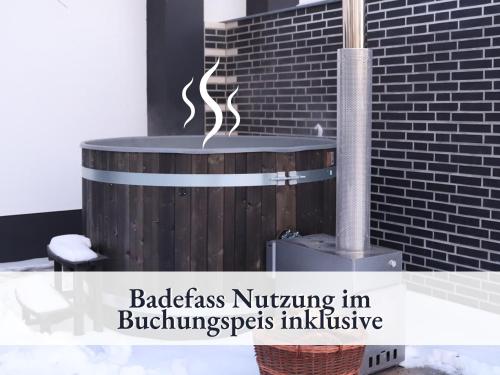 a fireplace in a room with a brick wall at Fewo Lake I Kamin I inkl Badefass I inkl Sauna I 2 Schlafzimmer in Wendisch Rietz