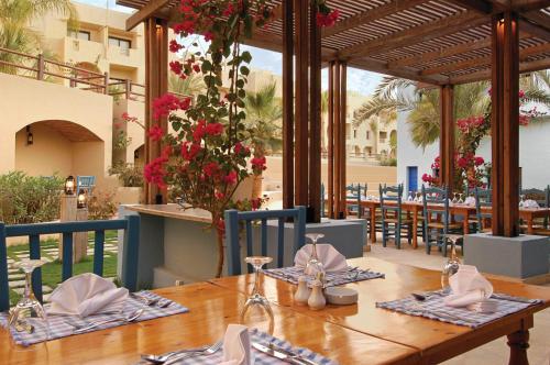 a dining room with a table and chairs on a patio at Marina Lodge at Port Ghalib in Port Ghalib