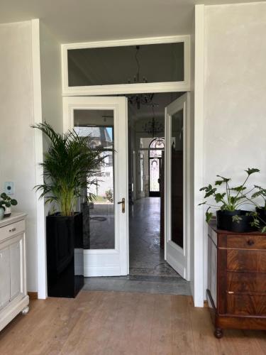 an open hallway with potted plants in a house at Boutique Hotel Marie Marie in Dendermonde