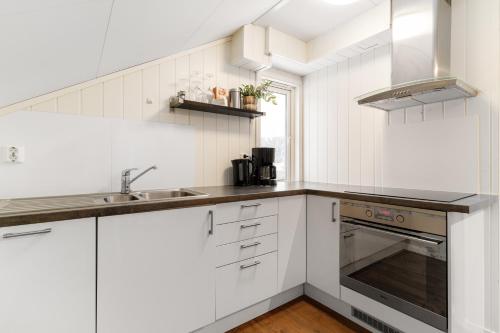 a white kitchen with a sink and a stove at 3 Bedroom Appartment Close To The Technologypark and University in Kongsberg