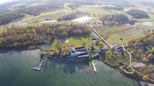 an aerial view of a house on an island in the water at Mauritzbergs Slott & Golf in Mauritsberg