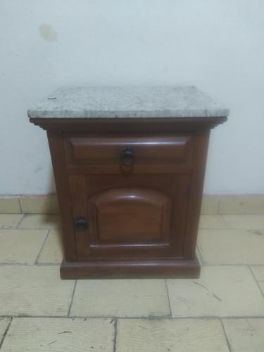 a wooden table with a granite counter top on a floor at Casa da Flávia in Búzios