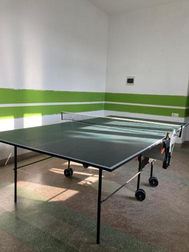 a ping pong table sitting in a room with at Green Kitchen Apartments in Mukacheve