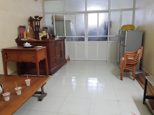 a kitchen with a table and a desk and a refrigerator at Mr. Khởi in Kim Côn