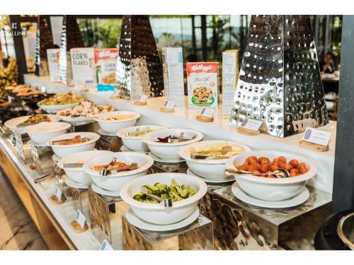 a buffet line with bowls of food on display at Colline Dalat in Da Lat