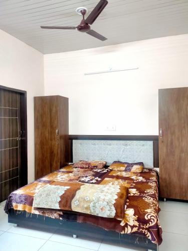 a bedroom with a bed and a ceiling fan at SHUBHAM VILLA -- Super Deluxe Rooms -- LPU Law Gate in Phagwāra