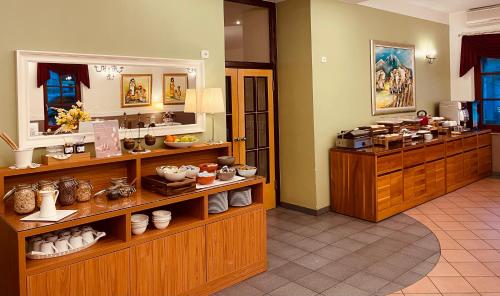 a room with a counter with dishes and vases at Hotel Delalut in Ravne na Koroškem