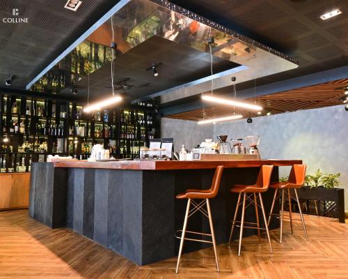 a bar in a restaurant with orange bar stools at Colline Dalat in Da Lat