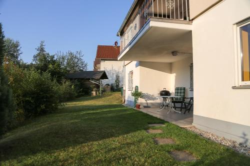 a backyard of a white house with a grass yard at Taunusblick-Meißner in Schmitten