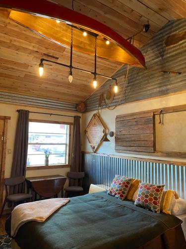 a bedroom with a large bed in a room at Dusty Boots Motel & Cafe in Cloudcroft