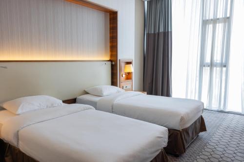 サムスンにあるアネモン サムスン ホテルのベッド2台と窓が備わるホテルルームです。