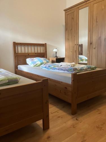 a bedroom with two twin beds and a mirror at St. Florian Restaurant & Pension in Vrakúň