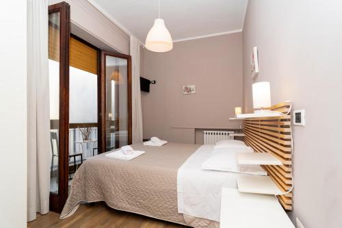 Кровать или кровати в номере Ostello Le Sirene