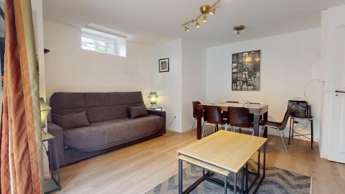 un salon avec un canapé et une table dans l'établissement Les appartements de Georges avec parking, à Colmar