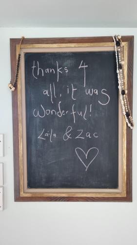 a chalkboard with a message written on it at Raglan West Retro Beach Vibe Accommodation in Raglan