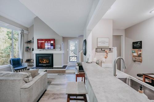 a living room with a couch and a fireplace at 45SW-Fireplace-Dishwasher-Washer Dryer-Sleeps 4 condo in Glacier