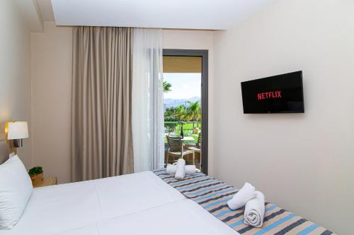 a hotel room with a bed and a balcony at Theo Star Beach Hotel in Malia