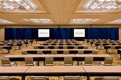 an empty lecture hall with tables and chairs at The Westin Cincinnati in Cincinnati