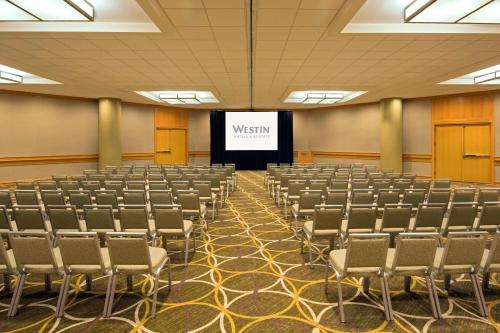an empty lecture hall with a screen with the words wisdom at The Westin Cincinnati in Cincinnati