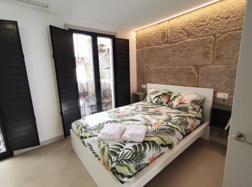 a bedroom with a bed with avertisement for at Cánovas 21 in Carballino