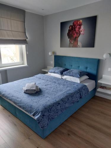 a bedroom with two beds and a blue bedspread at Apartament Margot - Centrum in Tarnów