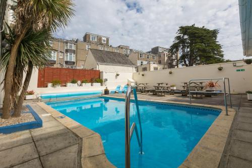 a swimming pool with blue water in front of a building at Eliot Hotel in Newquay