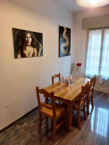 a dining room table with chairs and a painting on the wall at Deluxe Appartament near Racetrack 110 mq 4-5 People in Imola