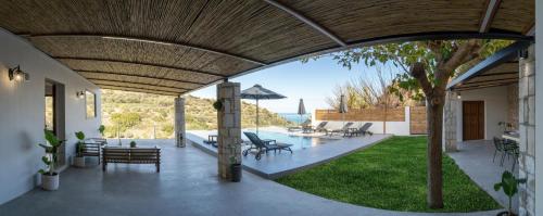 an external view of a house with a patio at Canyon 2 villa with private pool in Rethymno Town