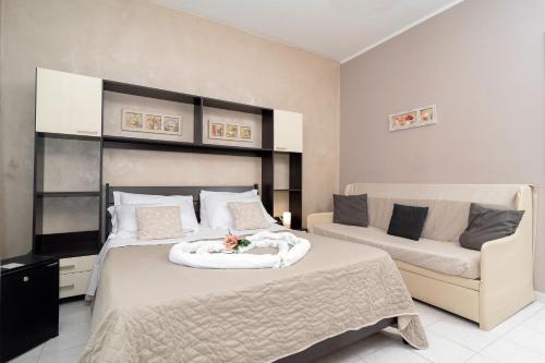 a bedroom with a bed and a couch at Casa Laura Sorrento in Sorrento