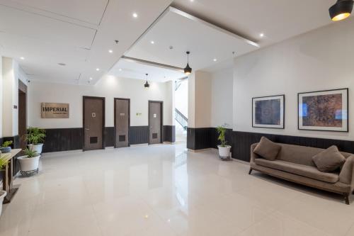 a lobby with a couch in the middle of a building at Ramada by Wyndham Kasauli in Kasauli