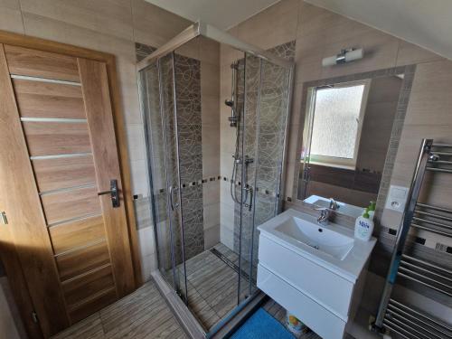 a bathroom with a shower and a sink at Apartmán Art in Zuberec